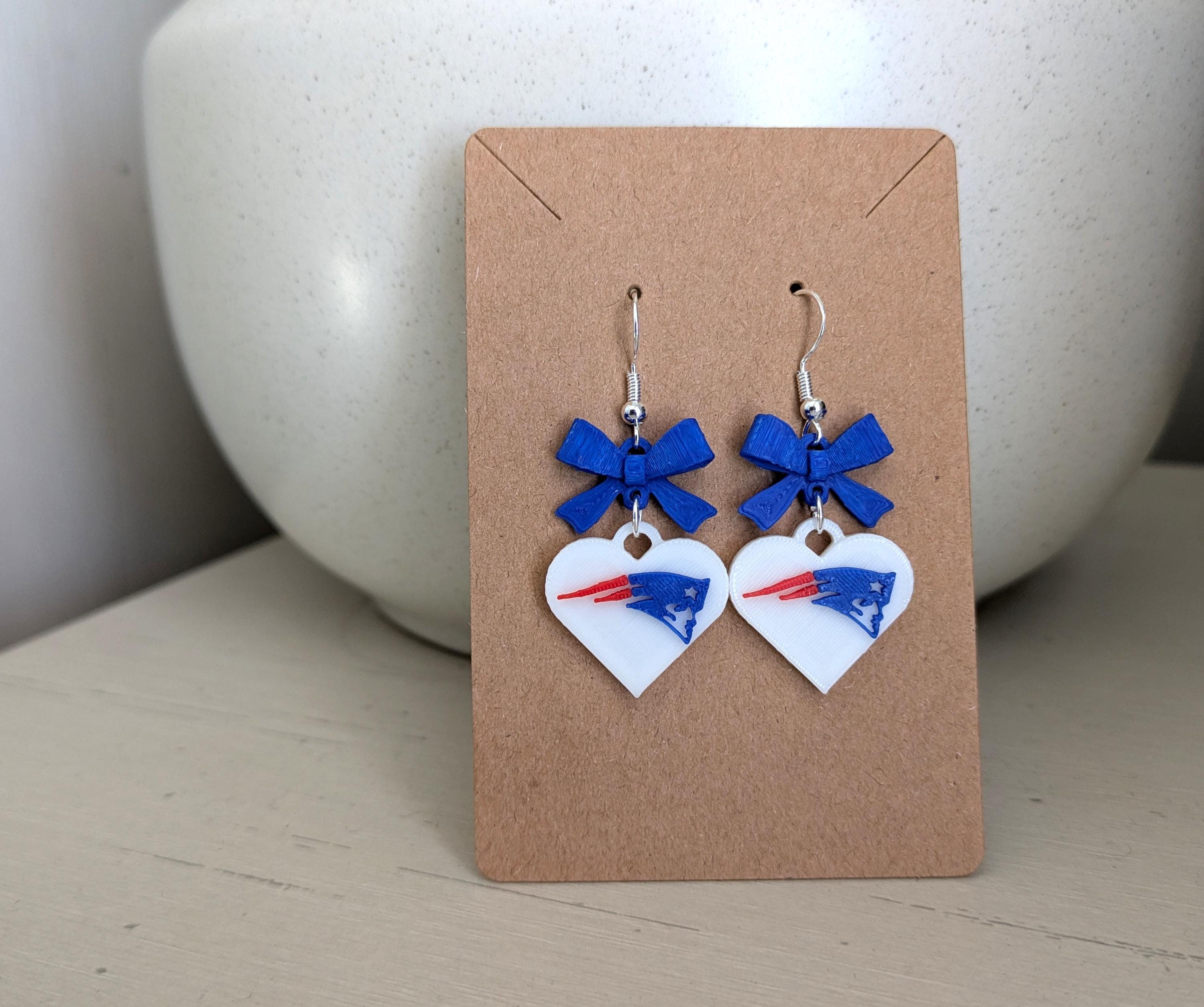 Patriots Blue & White Football Heart Earrings with Bow | Sports Fan Dangle Earrings | Game Day Jewelry | Handmade Statement Earrings